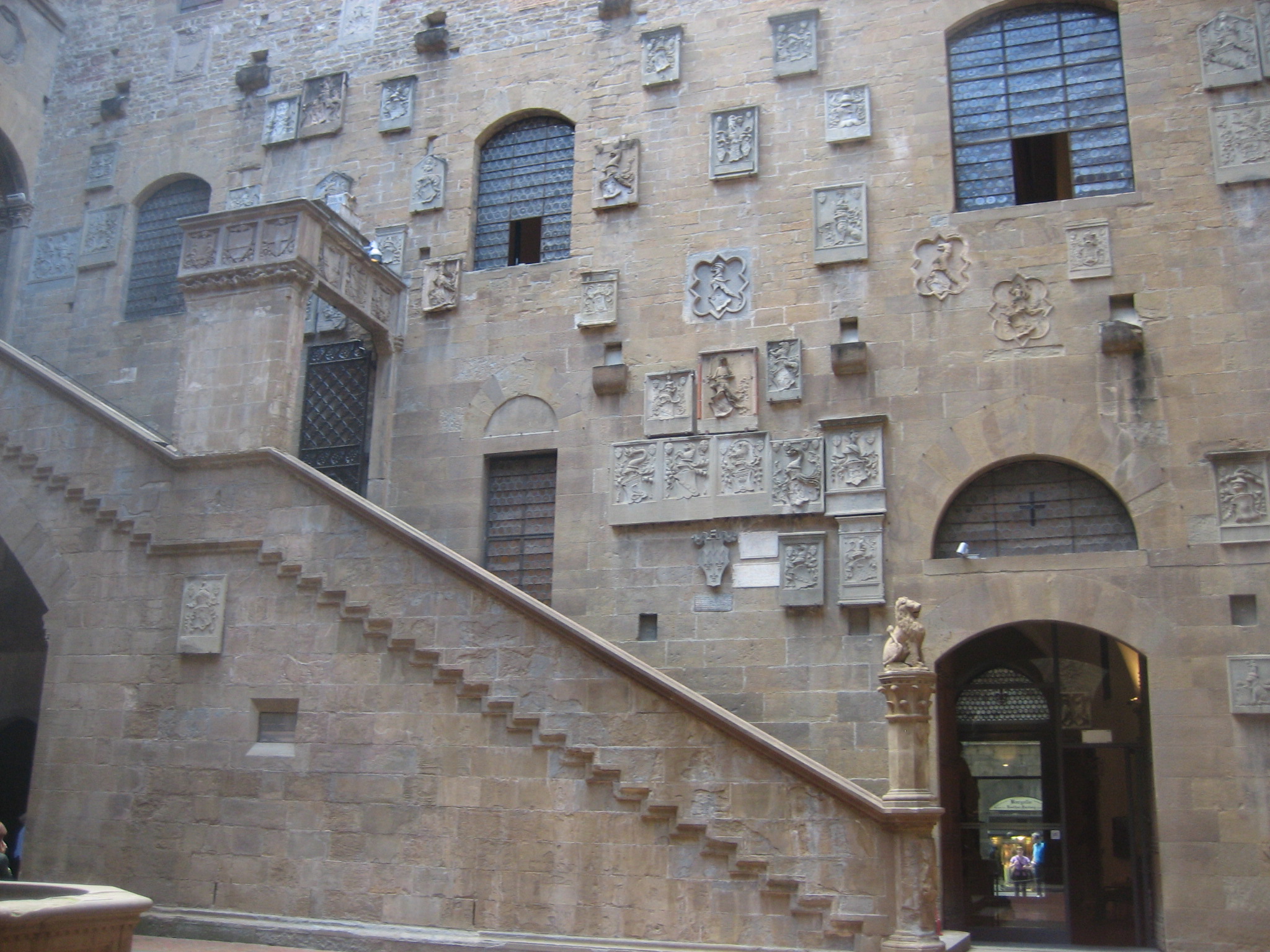 This photograph details the interior courtyard of The Bargello Museum. The stairwell leads to the second floor gallery which includes the display of Verrocchio's David and Donatello's David.